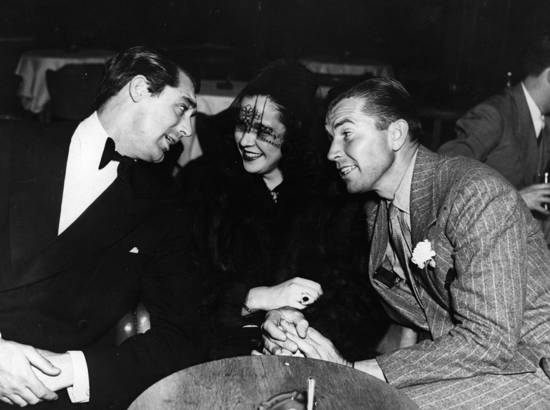 Gloria Vanderbilt surrounded by Cary Grant and Bruce Cabot, c. 1940